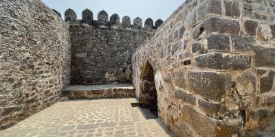 Bride and groom at Golconda Fort arched pathway